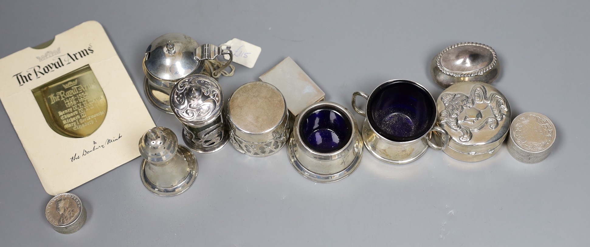 A small group of collectable small silver and white metal items including two pairs of 19th century sugar tongs(one a.f.), later condiments, match sleeve, dish pill box, etc.